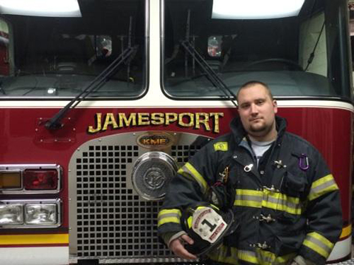 Lt. Stevie Czelatka Jr. in front of a Jamesport fire engine. (Courtesy file photo)