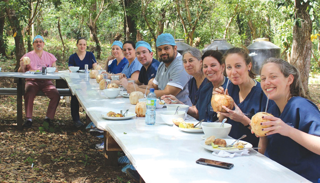 Voluneers from Peconic Bay Medical Center eat lunch at the David V. King Medical Center in Jacuapa, El Salvador. The team participated in a one week medical mission trip where they performed 67 surgeries on needy patients. (Credit: Laura Kelly)