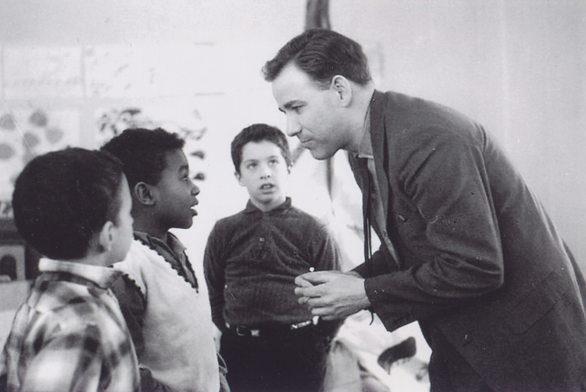 Mr. Swan converses with some young students in an undated photo. (Credit: courtesy photo)