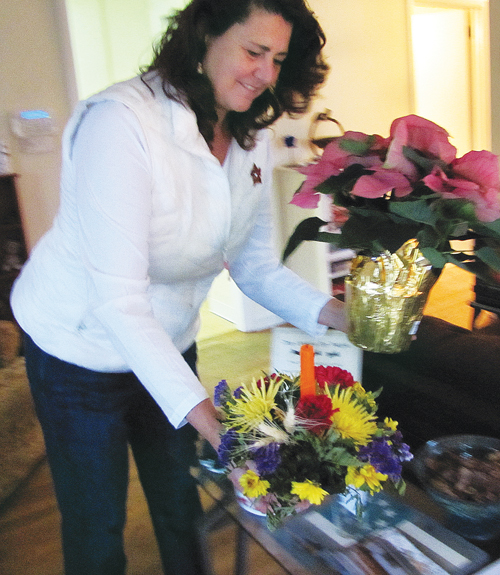 Ms. Pike rearranges flowers for Saturday's open house. (Credit: Paul Squire)