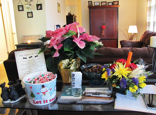 Candy canes, flowers and other decorations — including a holiday-themed doormat and Christmas table runner — helped make this open house in Mattituck more appealing, said real estate agent Beth Pike. (Credit: Paul Squire)