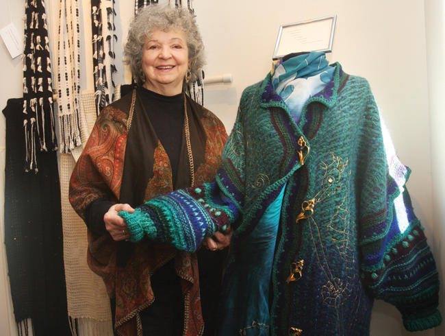 Ms. Ringewald with 'The Octopus's Garden,' an experimental coat that took her months to weave. The coat is part of her 'Weaving My World' exhibit on view through December at Cutchogue New Suffolk Free Library. (Credit: Barbaraellen Koch)