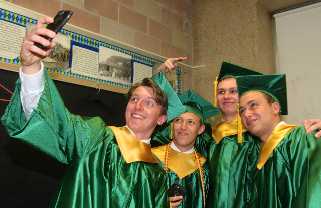 Aldo Geraci of Riverhead (from left), Alex Frabizio of Patchogue, Josh Elio of Shirley and Nick Gardner of Riverhead pose for a selfie after donning their graduation gowns and caps. (Credit: Barbaraellen Koch)