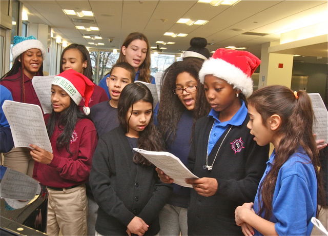 The Riverhead Charter School choir sing in the lobby of Peconic Bay Medical Center Tuesday. (Credit: Barbaraellen Koch)