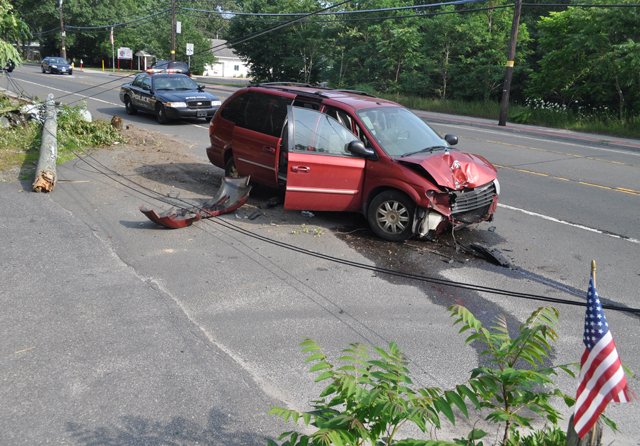 A mini-van carrying six people crashed into a telephone pole on Flanders Road Sunday afternoon. (Credit: Grant Parpan)