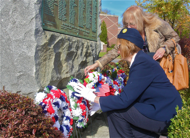 American Legion's Ladies Auxiliary vice president Darlene Folkes (left) and Fleet Reserve's Linda Chase place wreaths at the World War I memorial. (Credit: Barbaraellen Koch)