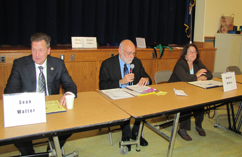 TIM GANNON PHOTO | Riverhead Town Supervisor Sean Walter, left and challenger Angela DeVito with moderator Sid Bail.
