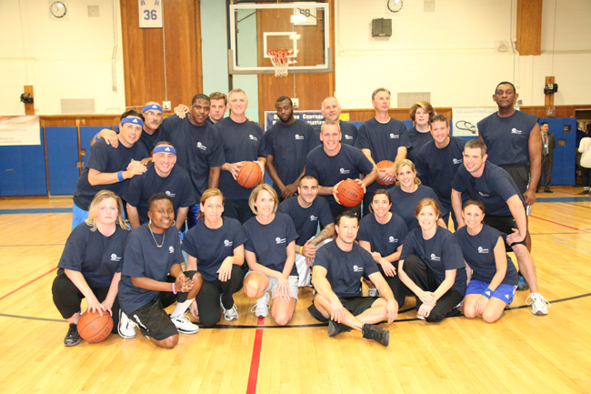 The Harlem Wizards pose with Riverhead faculty members at last year's game. (Credit: Riverhead School District)