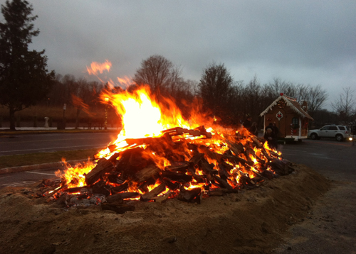 TIM GANNON PHOTO | Thousands of pieces of wood keep the annual bonfire roaring in downtown Riverhead.