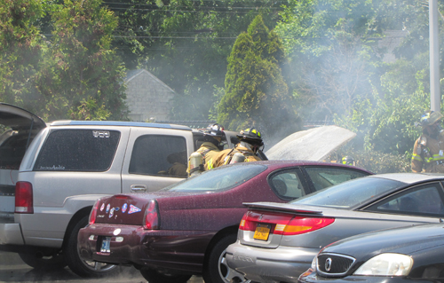 Riverhead firefighters put out a car fire Thursday afternoon. (Credit: Tim Gannon)