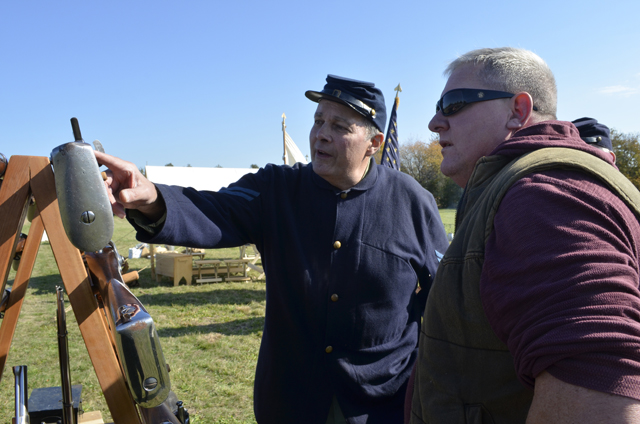 Dave Courtenay of  the 67th New York Volunteer Infantry’s Company K talks rifles with Steve Thompson of Baiting  Hollow.