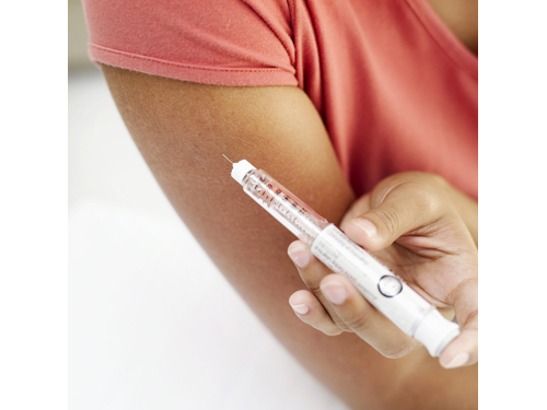 A woman self-administering insulin. (Credit: Corbis stock image)