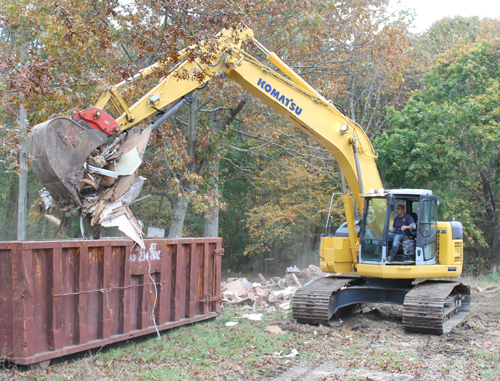 PAUL SQUIRE FILE PHOTO | An excavator clears debris during demolitions on Horton Avenue last fall.