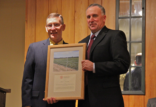 Cornell Cooperative of Suffolk County Agriculture Program director Dale Moyer honoring Mark Zaweski  (Credit: Carrie Miller)