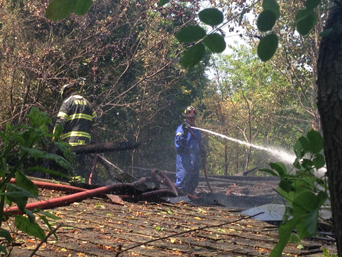 Fire crews put out a fire at an abandoned barn this afternoon in Calverton. (Credit: Paul Squire)