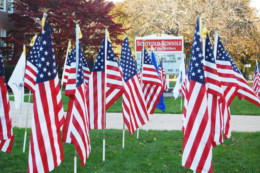 Southold freshmen and faculty members planted dozens of American flags outside the high school for Veterans Day. (Credit: Cyndi Murray)