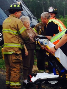 Firefighters check the driver for injuries after freeing her from her minivan Friday morning. (Credit: Cyndi Murray)