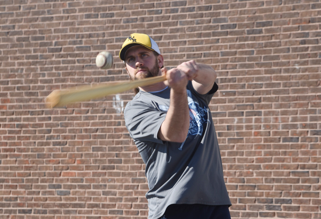 Shoreham-Wading River coach Kevin Willi hits fly balls Monday on the team's first day of official practices. (Credit: Robert O'Rourk)