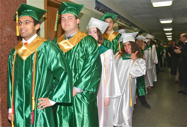 Graduates line the school hallway, while Natalie Massiah of Baiting Hollow playfully flashes a 'surf's up' hand sign. (Credit: Barbaraellen Koch)