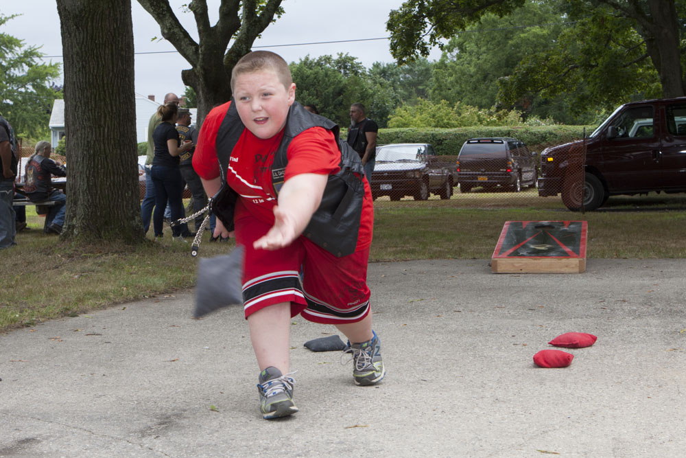 Jacob Cohen, 9, of Farmingville enjoys a game of bean bag toss. (Credit: Katharine Schroeder)