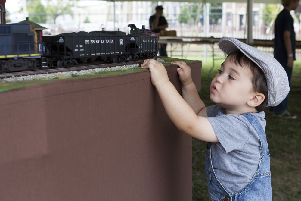 Cameron O'Leary, 2, of Port Jefferson makes the "choo choo" sound effect as the train goes by. (Credit: Katharine Schroeder)