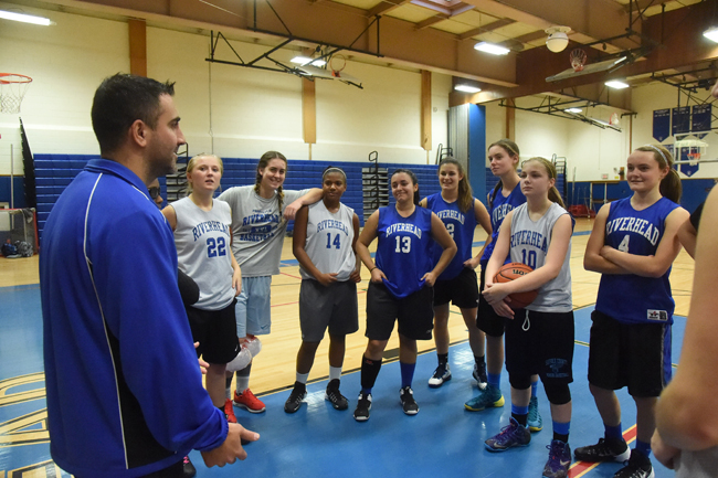 Riverhead girls coach Dave Spinella goes over instructions with the Blue Waves at practice. (Credit: Robert O'Rourk)