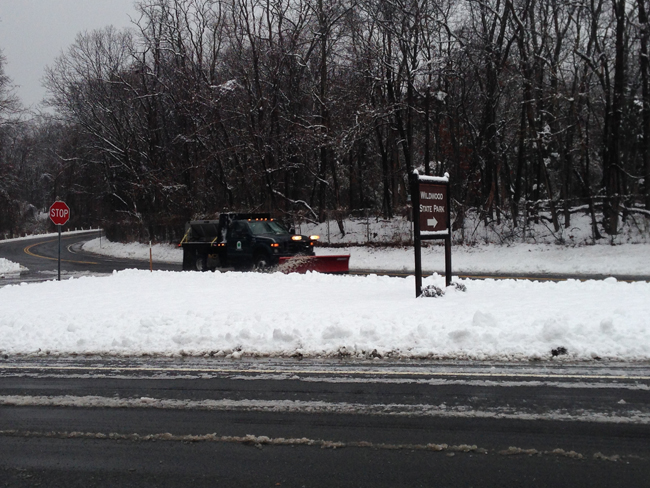 A plow clears snow near the entrance to Wildwood State Park in Wading RIver Saturday morning. (Credit: Joe Werkmeister)