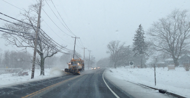 A plow clears snow on Main Road Friday. (Credit: Joe Werkmeister)