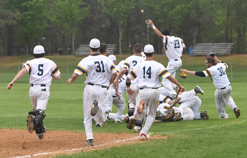 Shoreham-Wading River players are jubilant after Jack Massa scored on an infield error, capping a game-winning, four-run rally in the bottom of the seventh inning. (Credit: Robert O'Rourk)