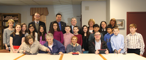 Southold Elementary School fifth graders  along with county Legislator Al Krupski and county Executive Steven Bellone taught Southold seniors Ana Balarezo, Judy Ollarty, Lena Raiser and Bill Faye how to use tablet computers Wednesday afternoon. (Credit: Carrie Miller)