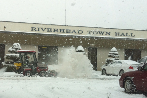 A town employee clears out the parking lot in front of Riverhead Town Hall Thursday morning. Tim Gannon photo.