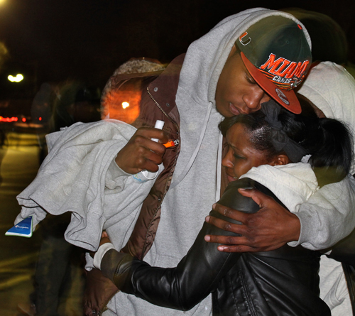 PAUL SQUIRE PHOTO | Mourners clung to one another for support during Thursday night's vigil for Demitri Hampton in Riverhead.