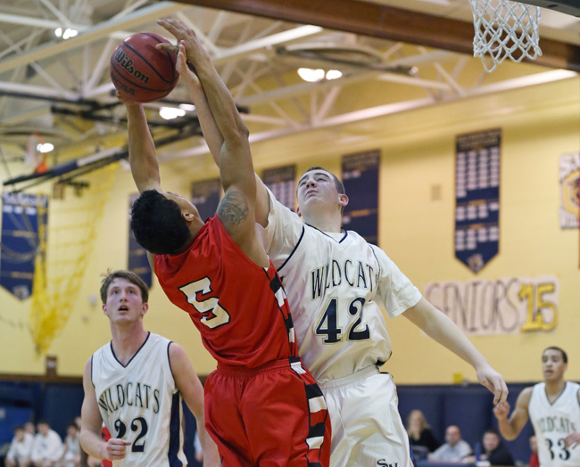 Shoreham-Wading River sophomore Ethan Wiederkehr goes up for a rebound against Mike Smith of Amityville. (Credit: Daniel De Mato)
