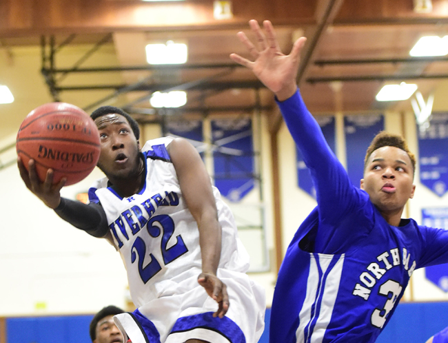 Riverhead's William Mitchell goes up for a shot against North Babylon's Tim Forbes. (Credit: Robert O'Rourk)